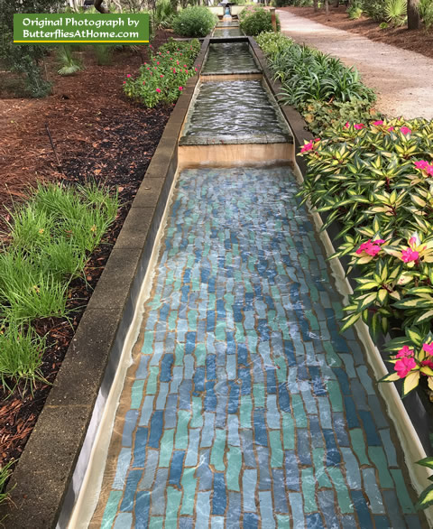 Water feature lined with New Guinea Impatiens at the Cerulean Park